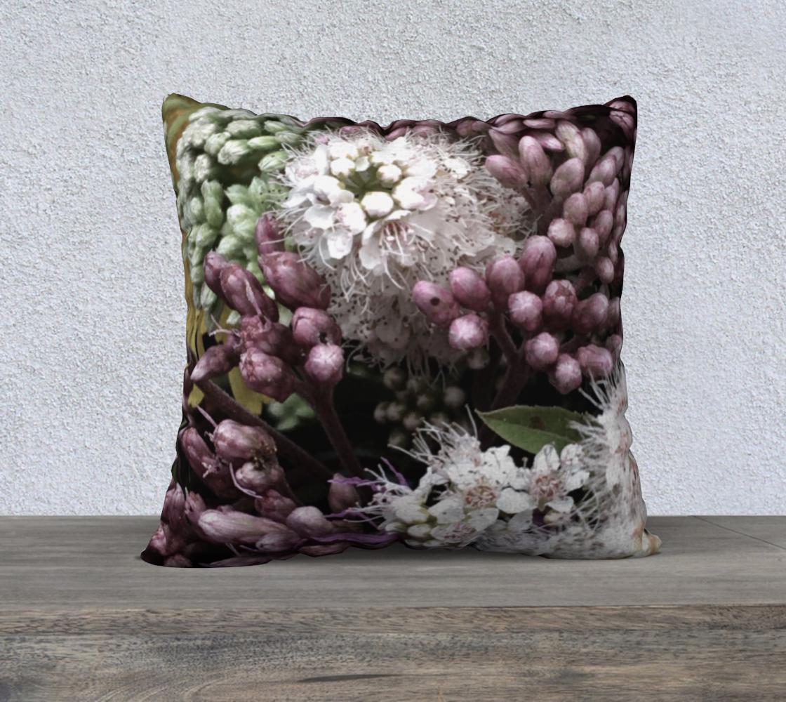 Bed of Flowers cushion front view showing wreath-like botanical arrangement with white starburst flowers, purple hyacinth clusters, pale green buds, and olive leaves