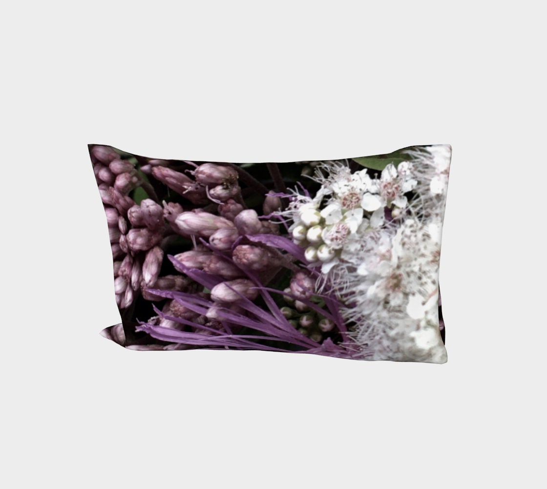Bed of Flowers pillow sleeve featuring deep purple hyacinth buds and clusters of delicate white flowers with visible stamens on a black background
