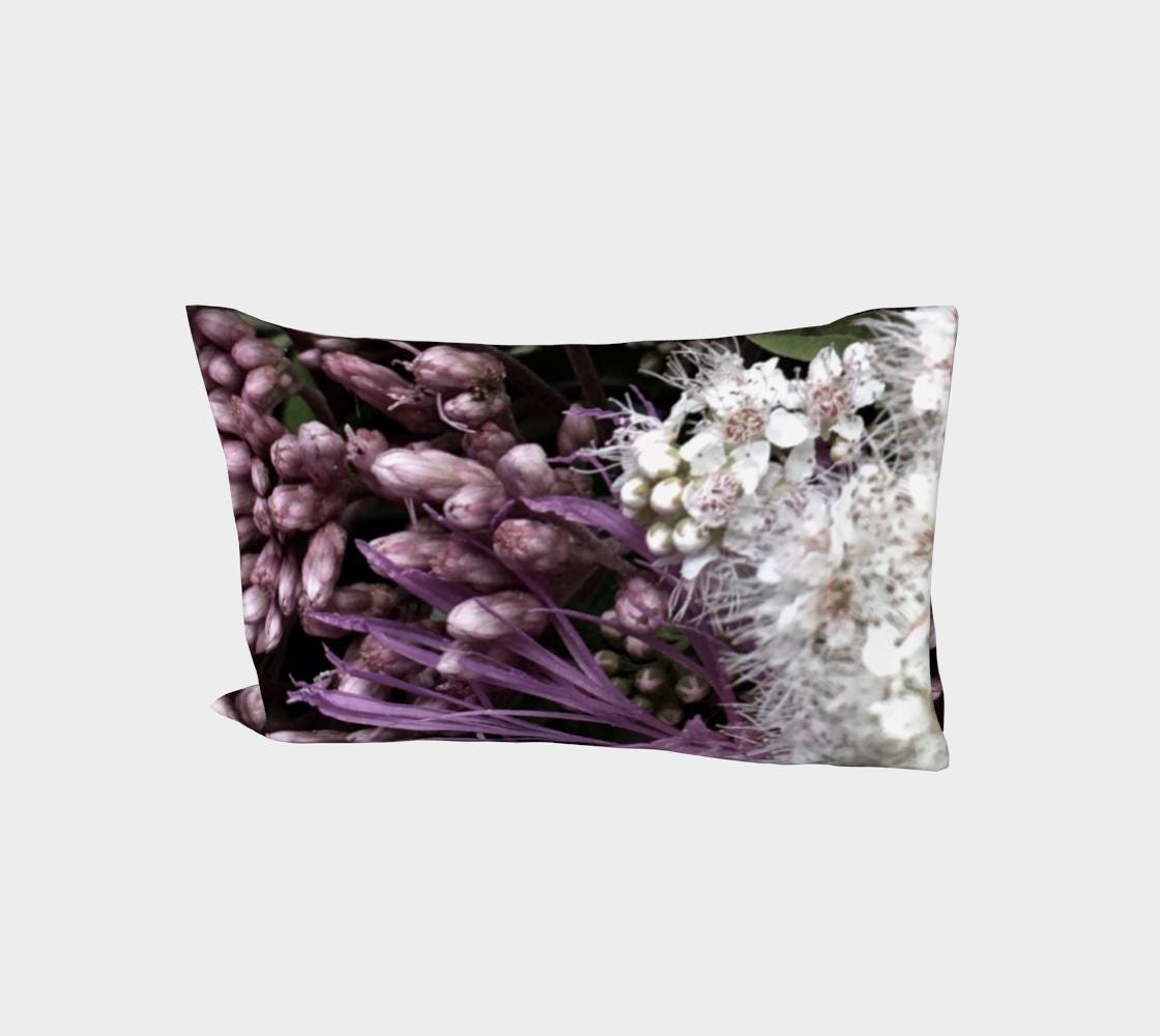 Bed of Flowers pillow sleeve featuring deep purple hyacinth buds and clusters of delicate white flowers with visible stamens on a black background